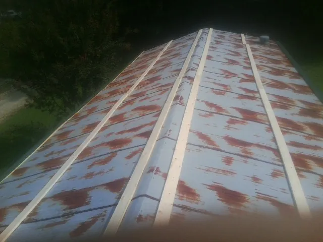 Rusted metal roof panels with new wood purlins before replacement — Storm Damage Roof Repair in Bargersville by Roofing Brothers