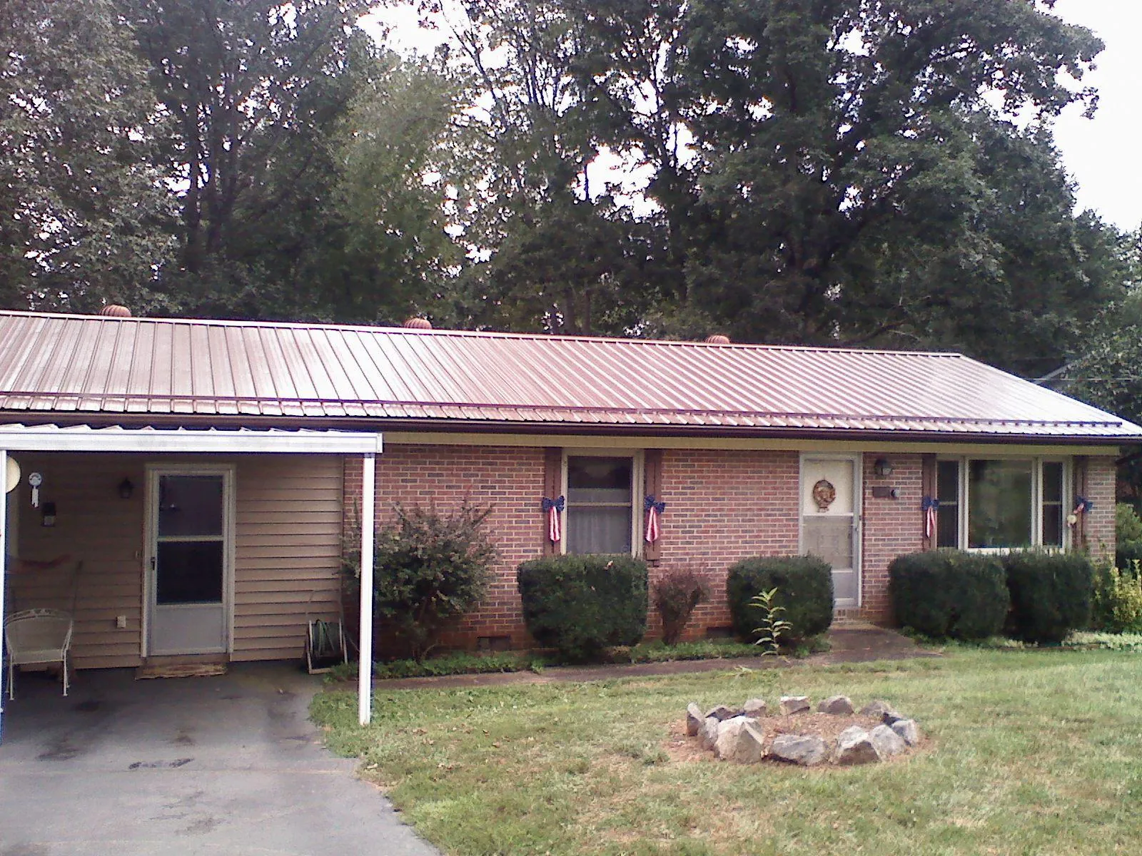Bronze metal roof and carport on a brick ranch home — Roof Repair work by our crew in Bargersville