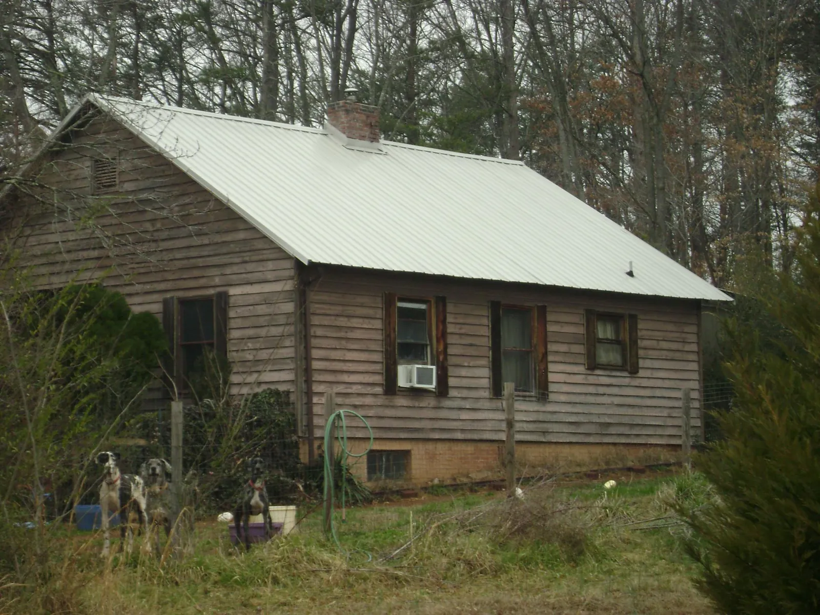 White metal roof on an old wood sided farmhouse, from a Metal Roof Installation job in Bargersville